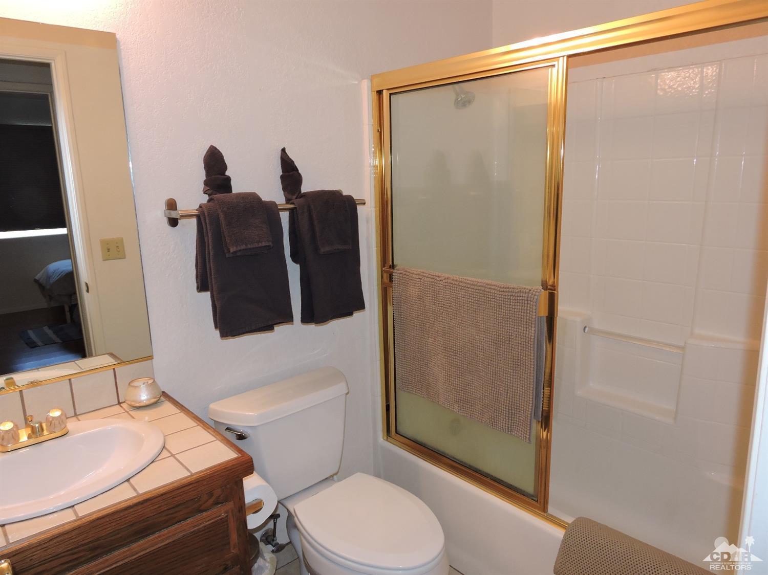 7369 Sunset Road Joshua Tree, CA 92252 - Photo 23 of 37 a bathroom with a toilet and a shower