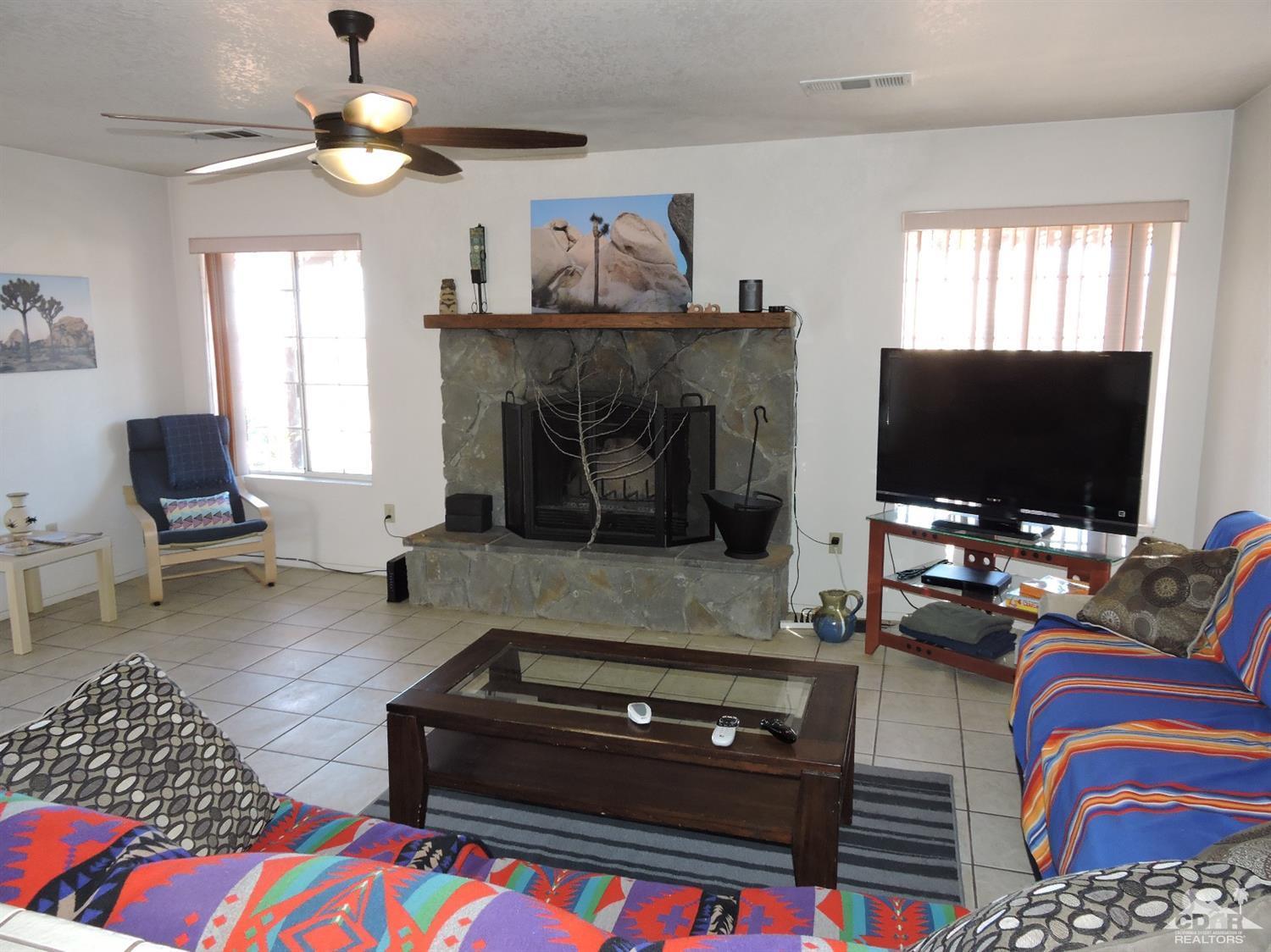 7369 Sunset Road Joshua Tree, CA 92252 - Photo 26 of 37 a living room with furniture and a flat screen tv