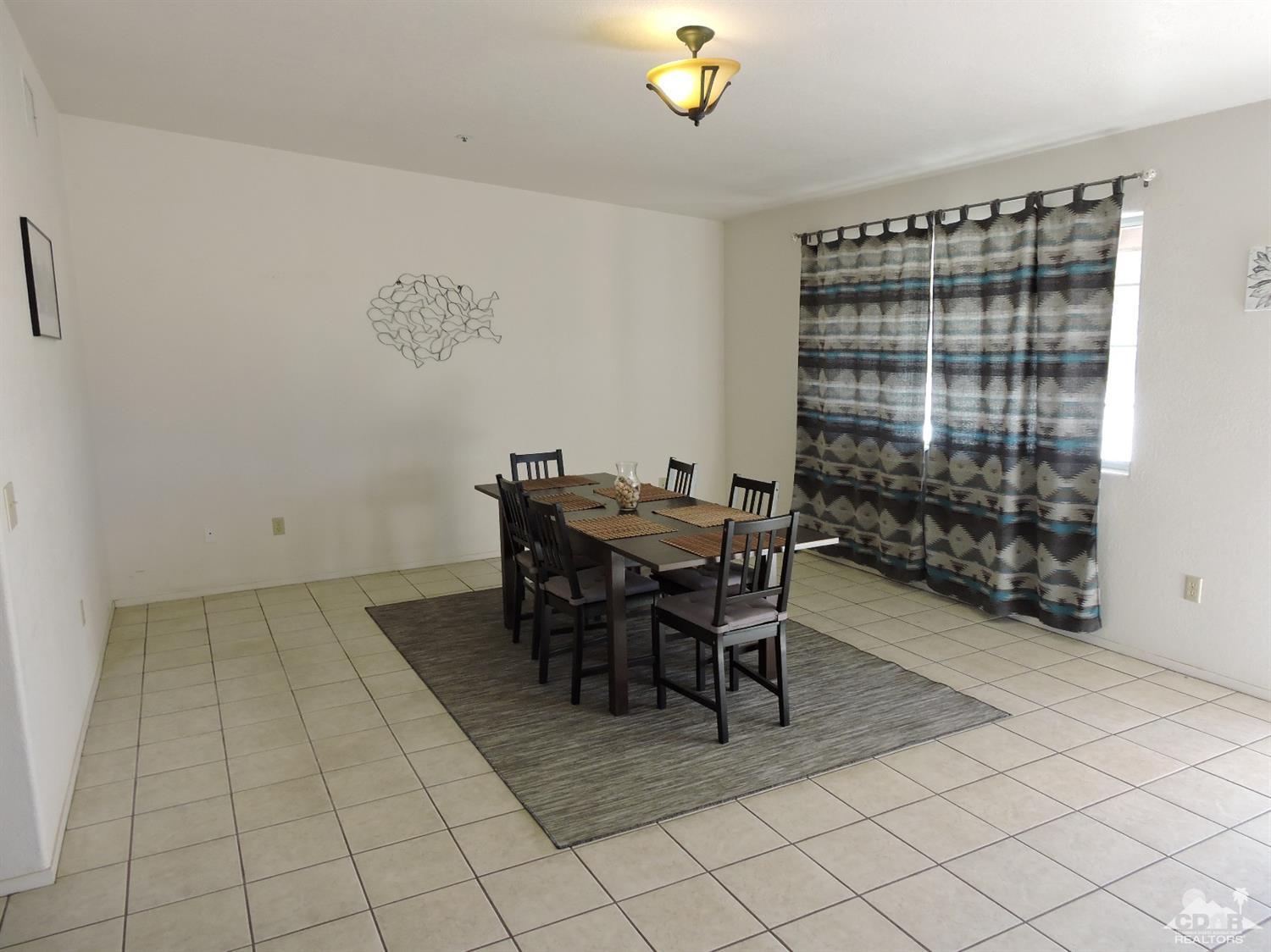 7369 Sunset Road Joshua Tree, CA 92252 - Photo 28 of 37 a view of a dining room with furniture and chandelier