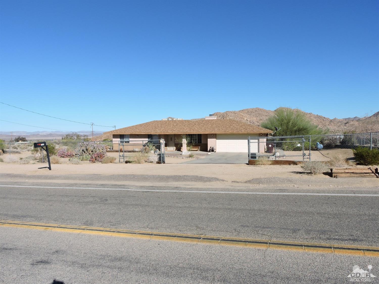 7369 Sunset Road Joshua Tree, CA 92252 - Photo 33 of 37 front view of a house with a yard