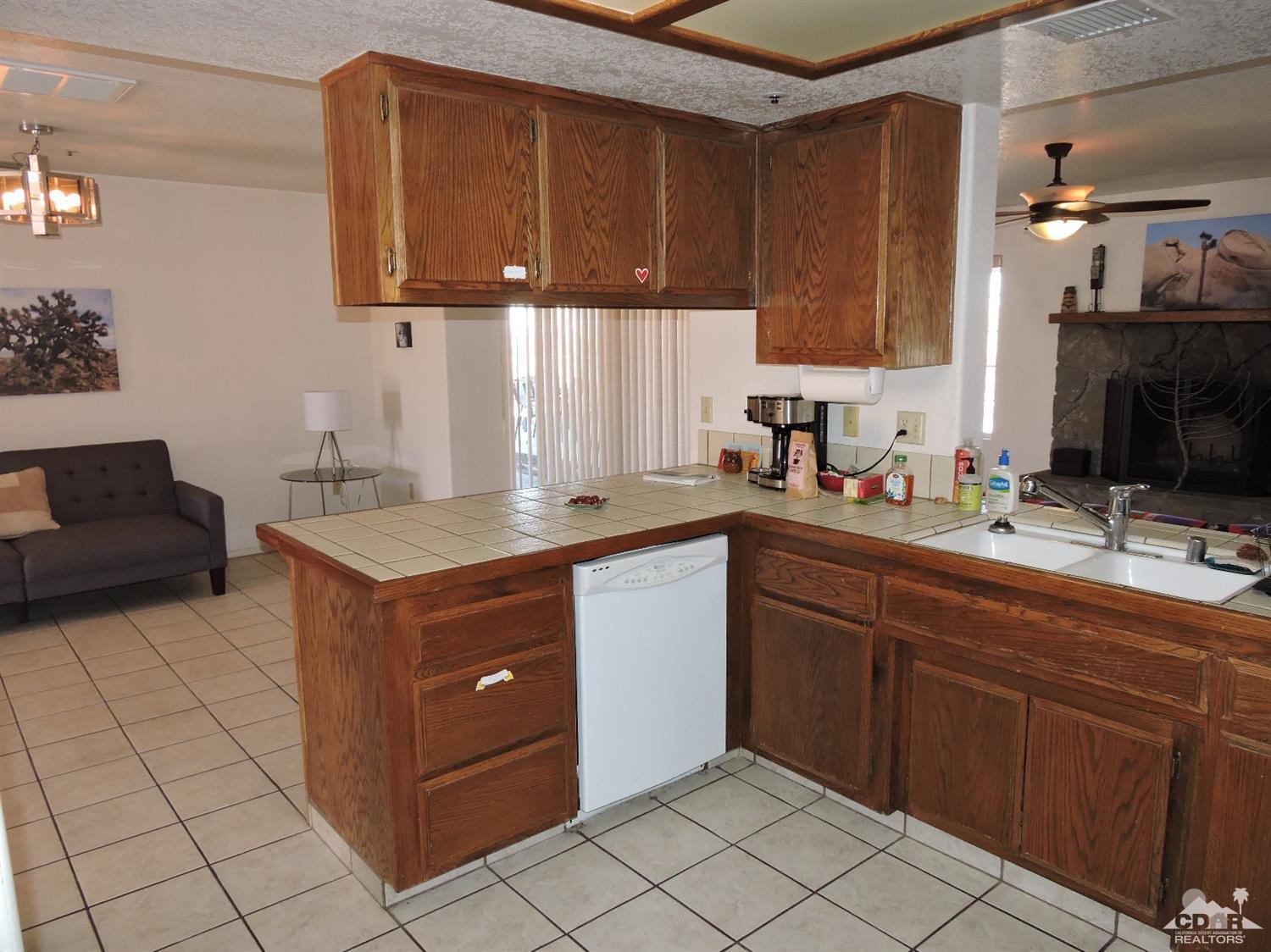 7369 Sunset Road Joshua Tree, CA 92252 - Photo 7 of 37 a kitchen with a cabinets and white appliances