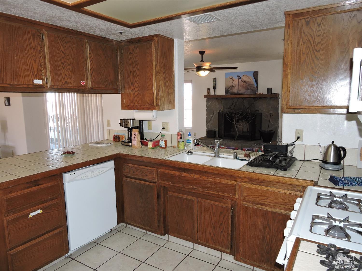 7369 Sunset Road Joshua Tree, CA 92252 - Photo 9 of 37 a kitchen with a sink and a stove top oven