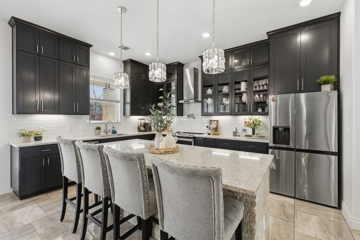1905 South College Street Georgetown, TX 78626 - Photo 11 of 37 a kitchen with stainless steel appliances granite countertop a sink refrigerator and cabinets
