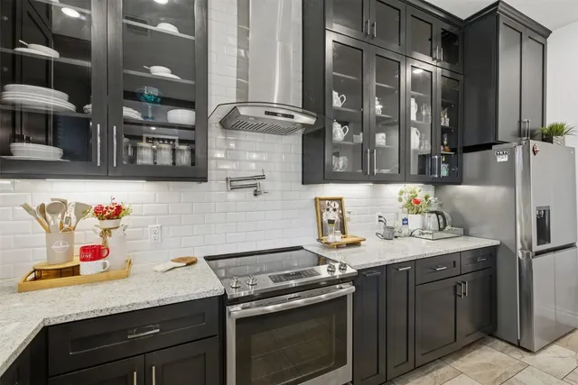 a kitchen with stainless steel appliances granite countertop a sink stove and cabinets