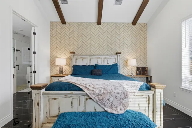 a bedroom with a bed and a window