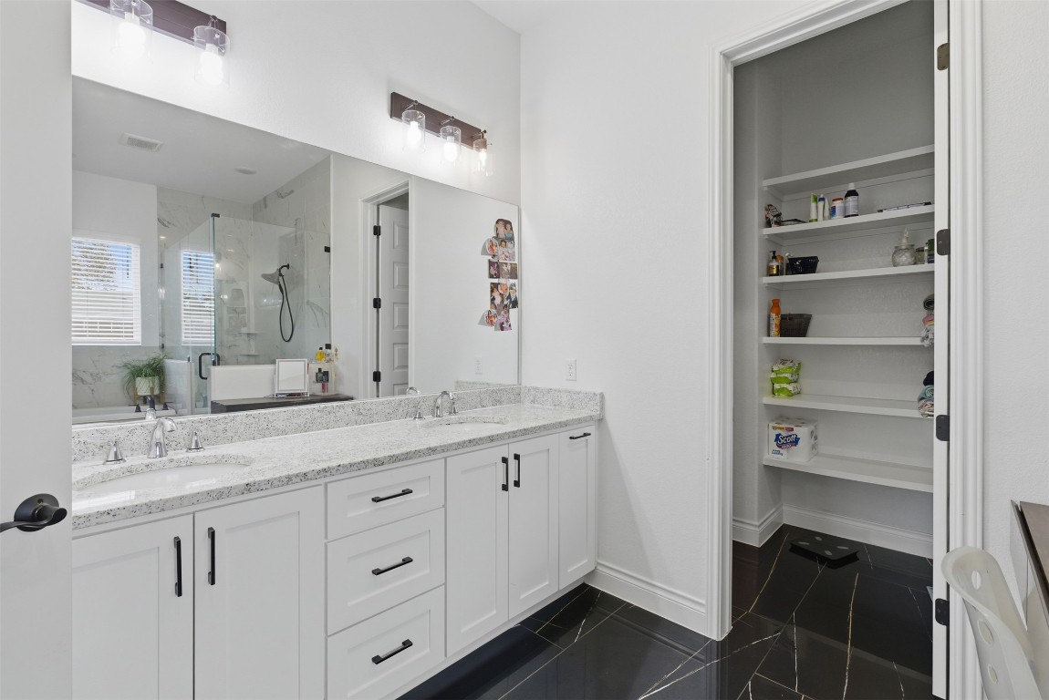 1905 South College Street Georgetown, TX 78626 - Photo 22 of 37 a bathroom with a granite countertop sink and a mirror