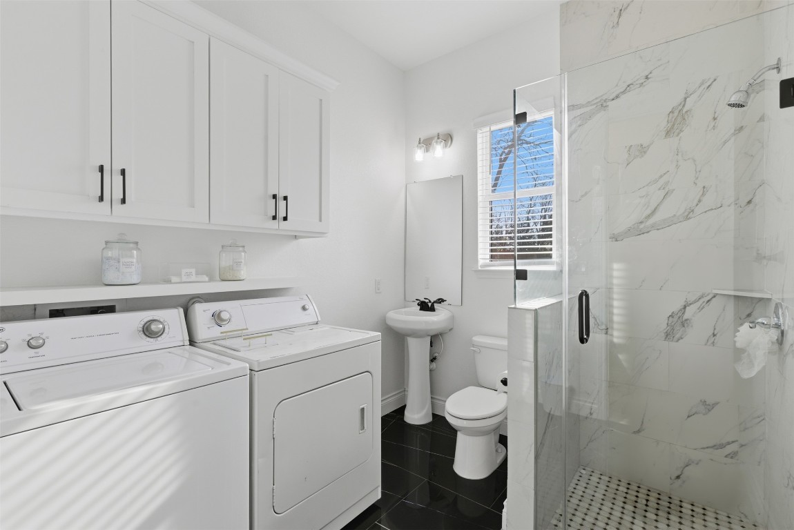 1905 South College Street Georgetown, TX 78626 - Photo 25 of 37 a bathroom with a granite countertop toilet and a shower