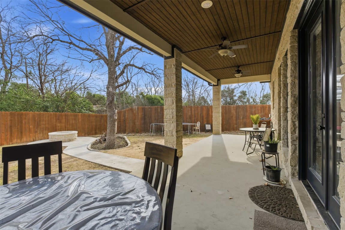 1905 South College Street Georgetown, TX 78626 - Photo 31 of 37 a view of a patio with a dining table and chairs with wooden floor and fence