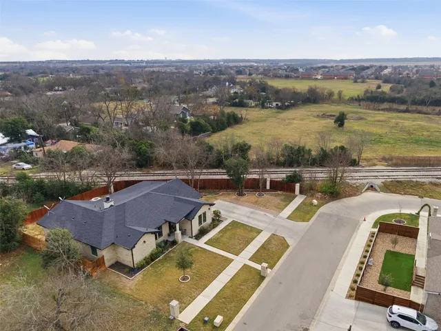 an aerial view of a house with a yard
