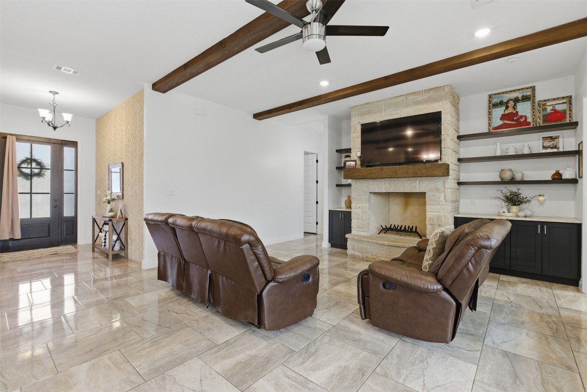 1905 South College Street Georgetown, TX 78626 - Photo 7 of 37 a living room with furniture a flat screen tv and a fireplace