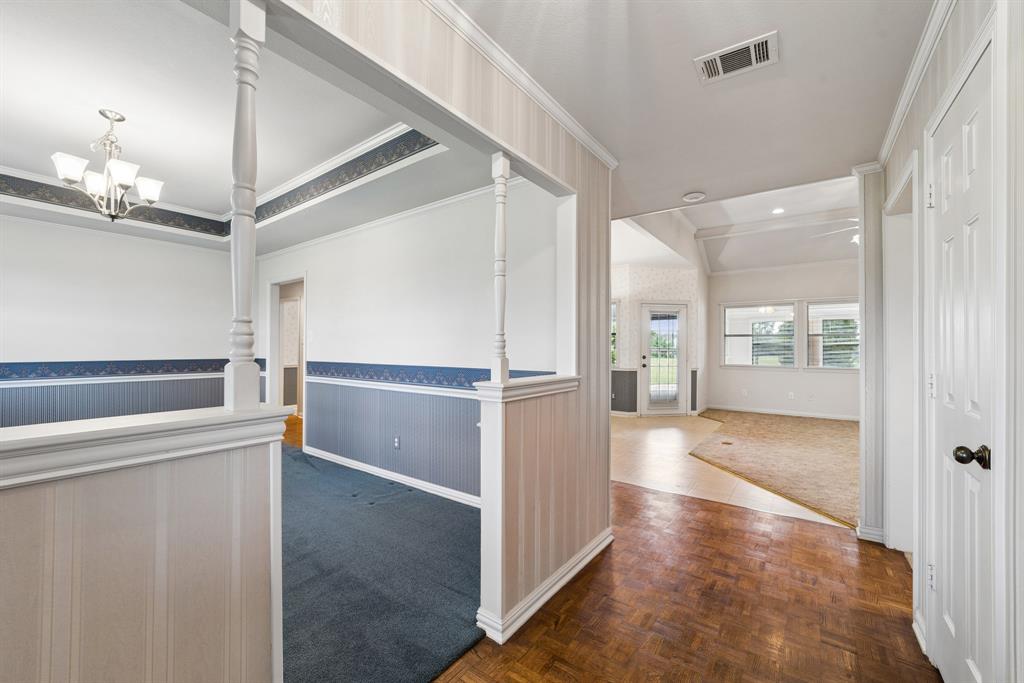 1175 Bloom Street Lucas, TX 75002 - Photo 5 of 36 a view of a hallway with white walls and chandelier