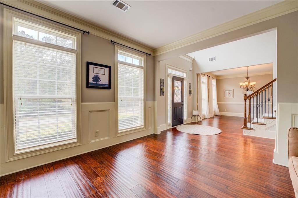 150 Alcovy Reserve Way Covington, GA 30014 - Photo 17 of 70 a view of an empty room with wooden floor and a window