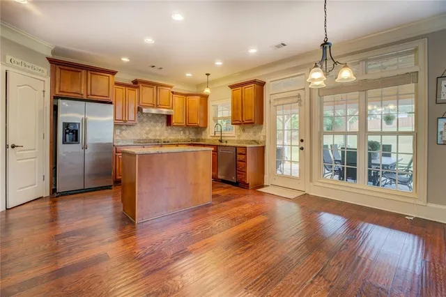 a spacious bedroom with a bed dresser and a window