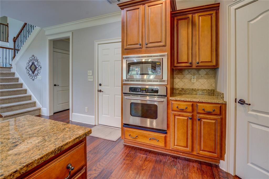 150 Alcovy Reserve Way Covington, GA 30014 - Photo 36 of 70 a kitchen with stainless steel appliances granite countertop a stove and a refrigerator