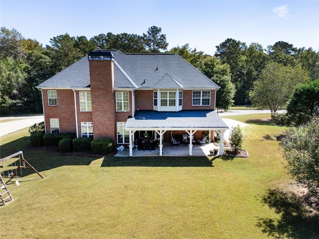150 Alcovy Reserve Way Covington, GA 30014 - Photo 4 of 70 a front view of a house with a yard table and chairs