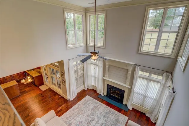 an empty room with windows and fan