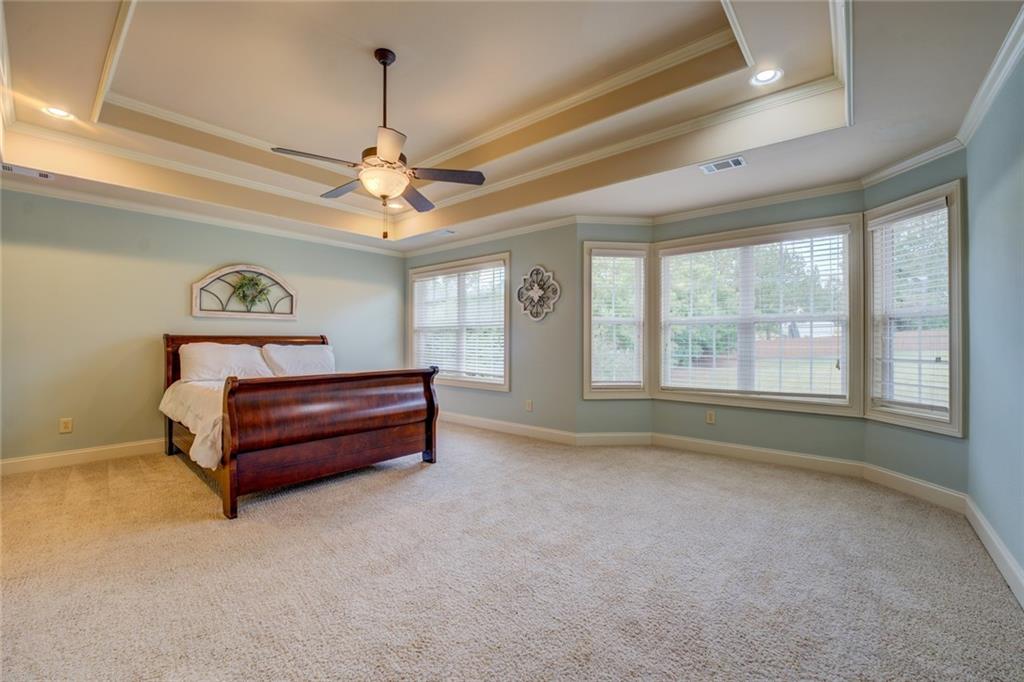 150 Alcovy Reserve Way Covington, GA 30014 - Photo 45 of 70 a spacious bedroom with a bed dresser and a window