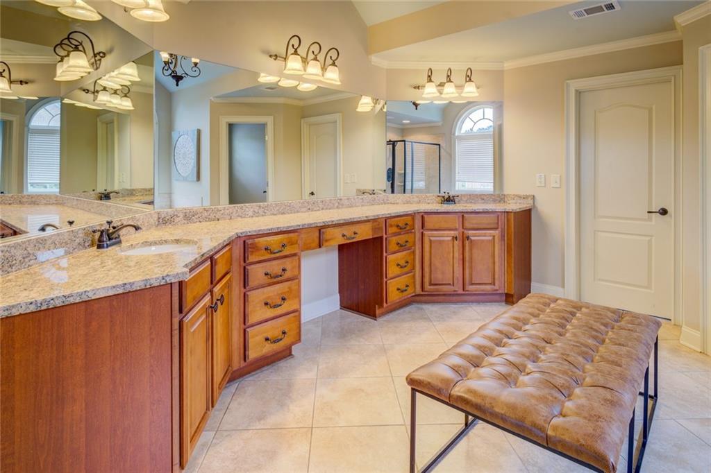 150 Alcovy Reserve Way Covington, GA 30014 - Photo 49 of 70 a spacious bathroom with a granite countertop double vanity sink a mirror a vanity and bathtub