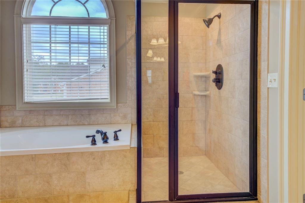 150 Alcovy Reserve Way Covington, GA 30014 - Photo 52 of 70 a bathroom with a bathtub and a shower