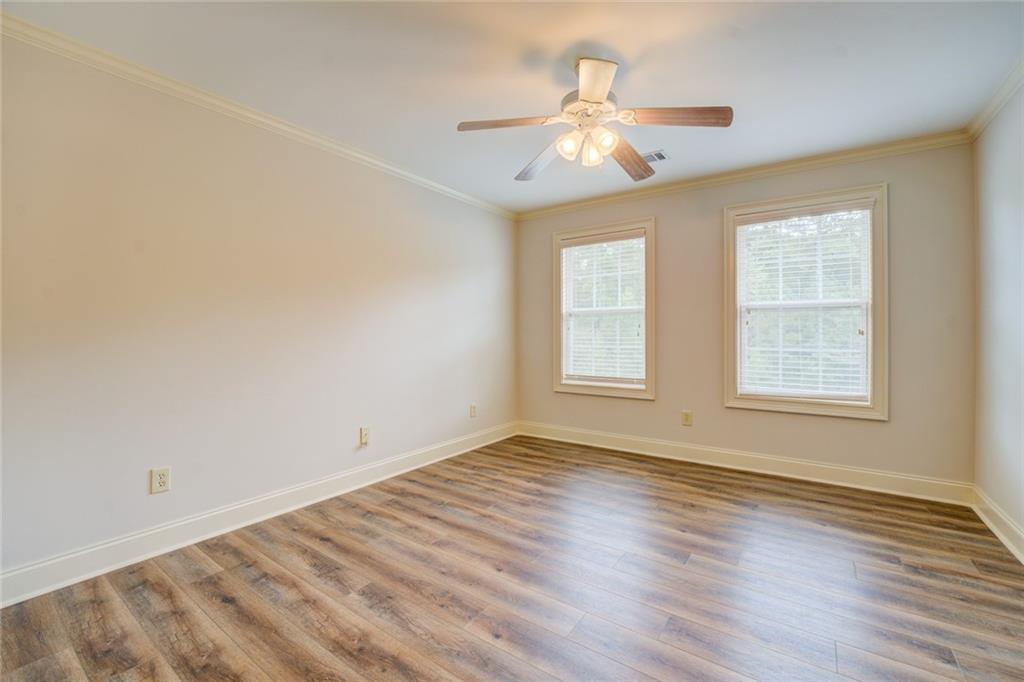 150 Alcovy Reserve Way Covington, GA 30014 - Photo 56 of 70 a view of an empty room with wooden floor and a window