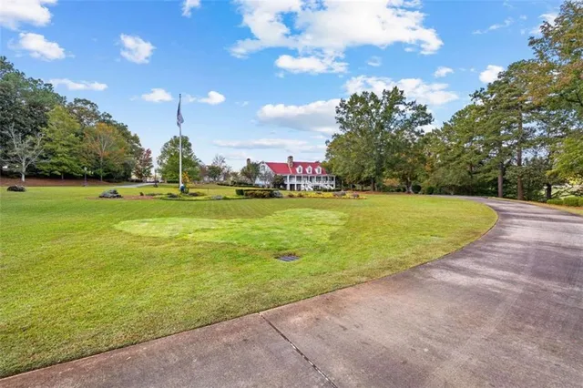 an aerial view of a house with a yard and lake view