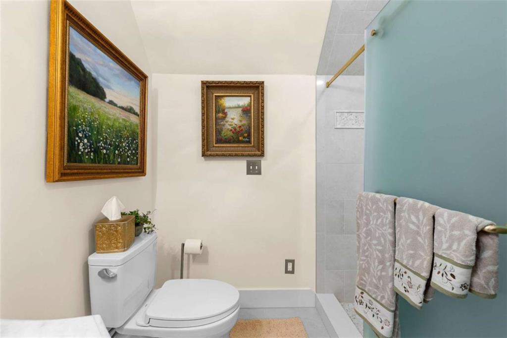 5225 Chalybeate Springs Road Woodland, GA 31836 - Photo 79 of 100 a white toilet sitting next to a bathroom sink and tub