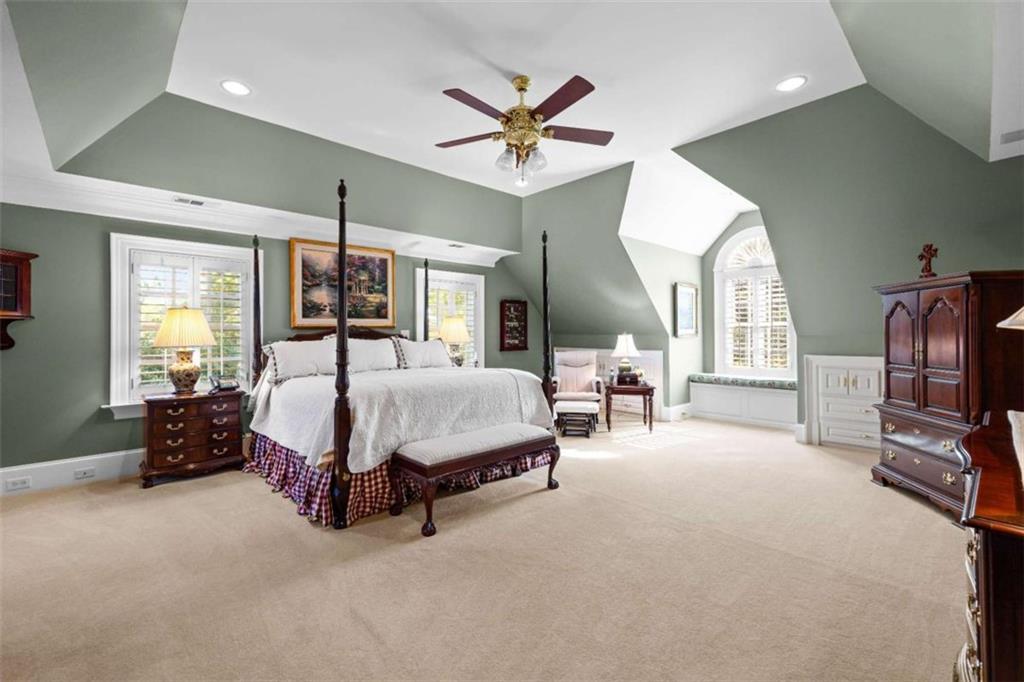 5225 Chalybeate Springs Road Woodland, GA 31836 - Photo 90 of 100 a spacious bedroom with a bed a couch and a chandelier