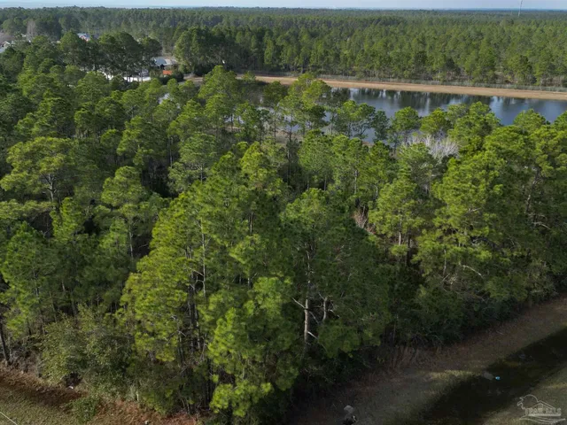 an aerial view of a houses with a yard