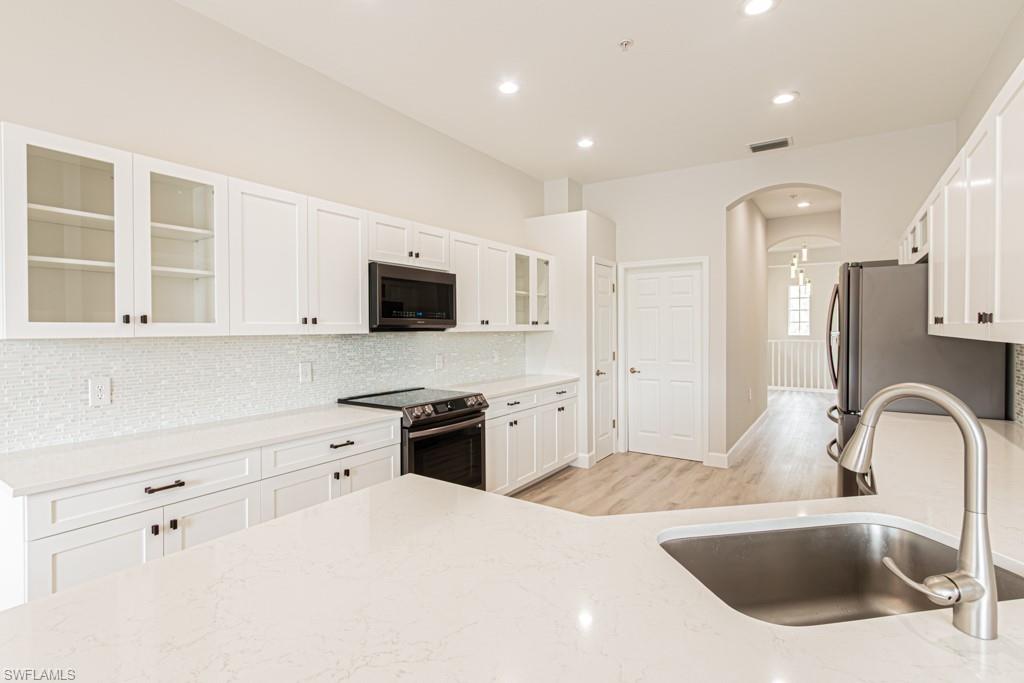 26448 Lucky Stone Road, Unit 202 Bonita Springs, FL 34135 - Photo 15 of 50 Fabulous kitchen-quartz counters, new backsplash, appliances, glass-fronted cabinets and more!