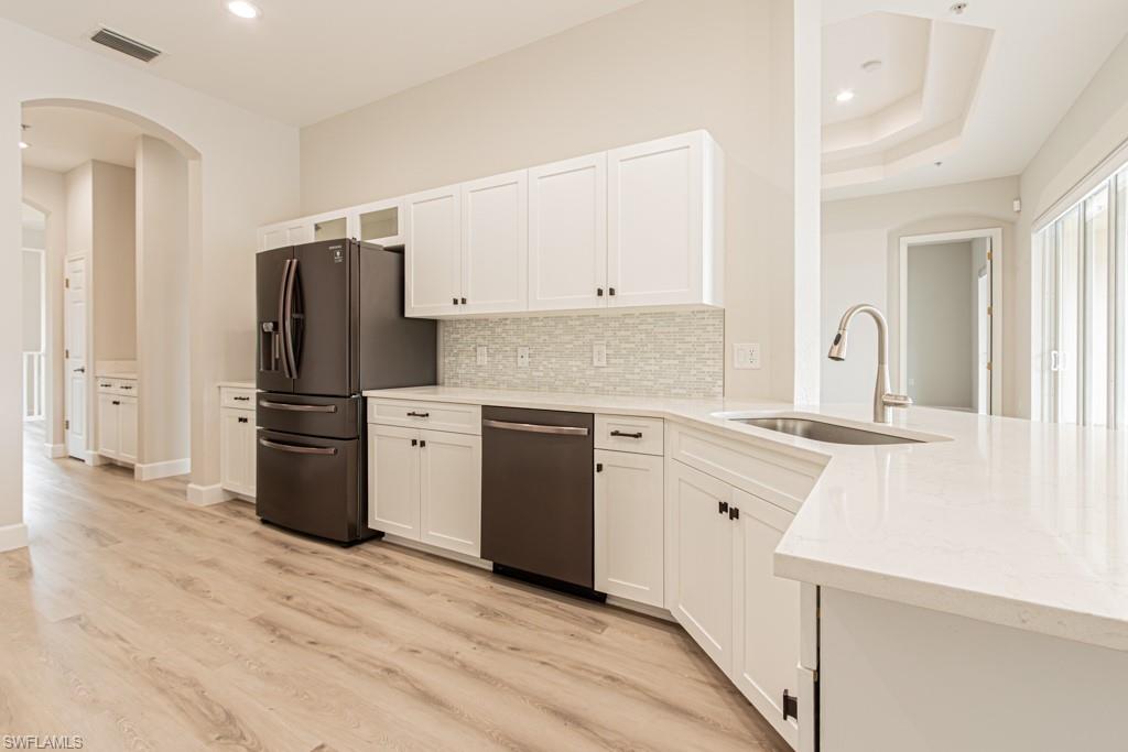 26448 Lucky Stone Road, Unit 202 Bonita Springs, FL 34135 - Photo 19 of 50 a kitchen with granite countertop a refrigerator stove and sink