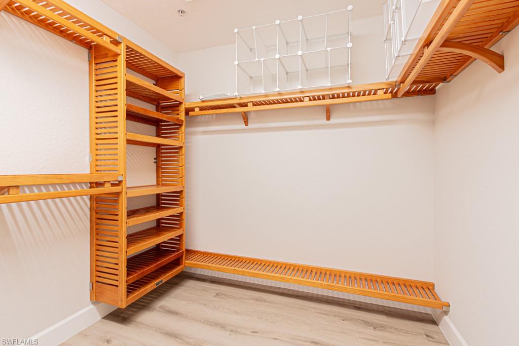 26448 Lucky Stone Road, Unit 202 Bonita Springs, FL 34135 - Photo 26 of 50 Custom wood shelving in both closets and linen closet in the bathroom
