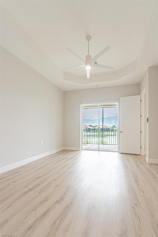 26448 Lucky Stone Road, Unit 202 Bonita Springs, FL 34135 - Photo 26 of 50 an empty room with wooden floor and windows