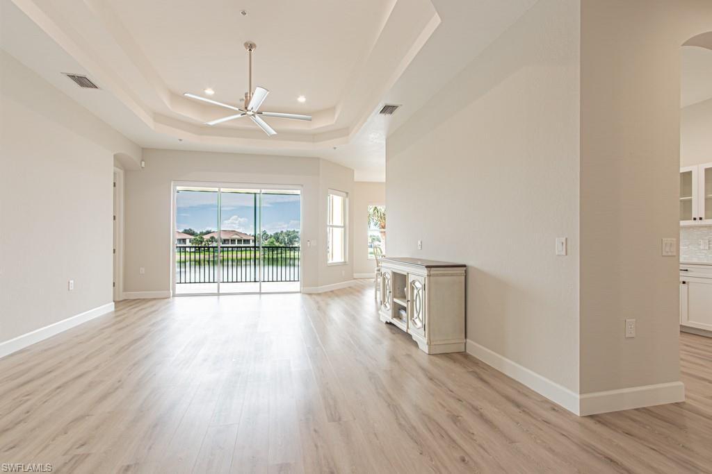 26448 Lucky Stone Road, Unit 202 Bonita Springs, FL 34135 - Photo 8 of 50 a view of a room with wooden floor and a ceiling fan