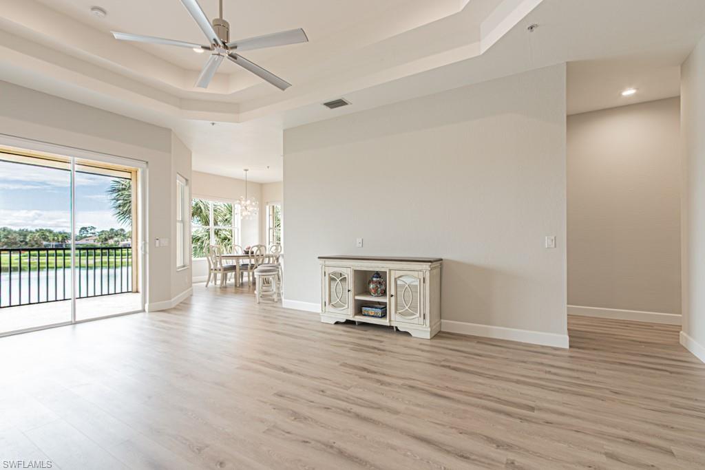 26448 Lucky Stone Road, Unit 202 Bonita Springs, FL 34135 - Photo 10 of 50 wooden floor in an empty room with a window