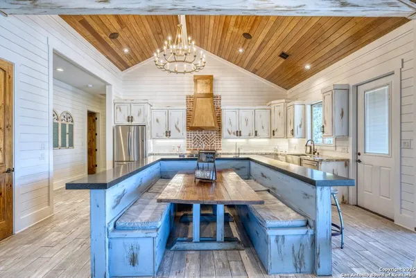 a view of a dining room with furniture a chandelier and wooden floor