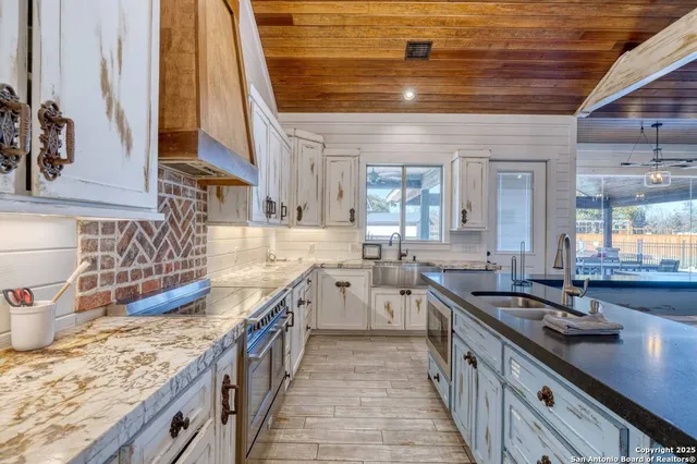 a kitchen with a sink stove and cabinets