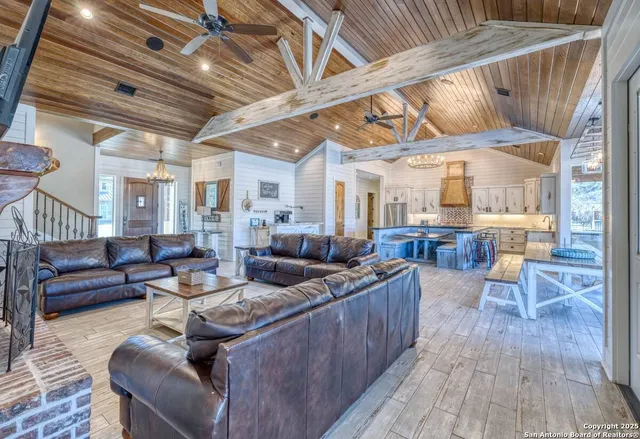 a living room with furniture and wooden floors