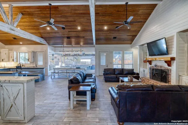 a living room with fireplace furniture and a flat screen tv