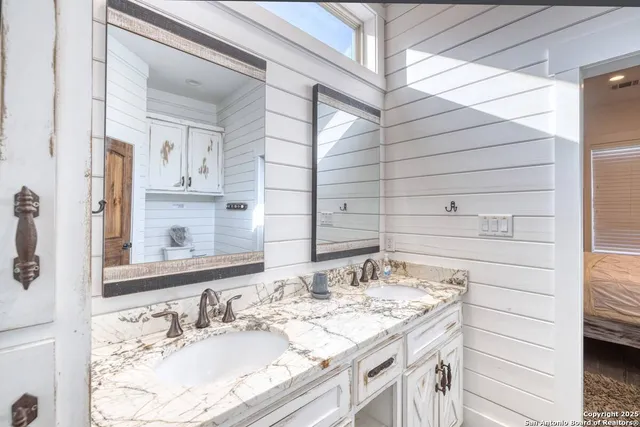 a bathroom with a sink and a mirror