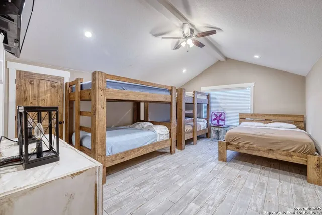 a bedroom with bed and a large mirror