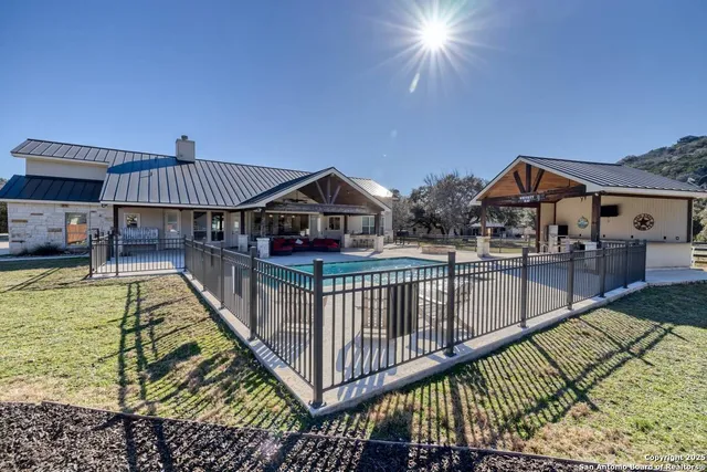 a view of a house with swimming pool and sitting area