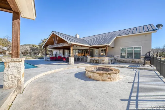 a view of a house with swimming pool and sitting area