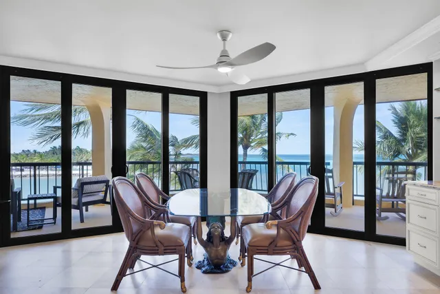 a bathroom with a granite countertop sink a toilet a mirror and shower