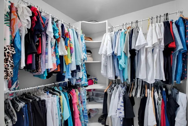 a bedroom with a bed and painting on the wall