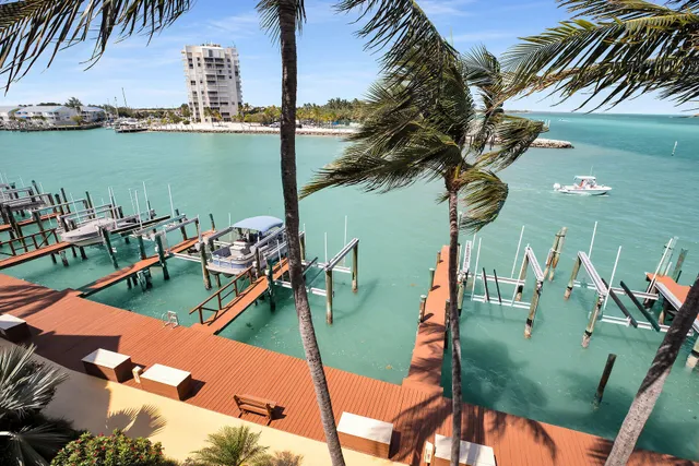 a kitchen with white cabinets and refrigerator