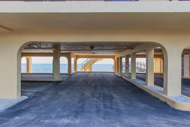 a front view of a building with glass windows and a table