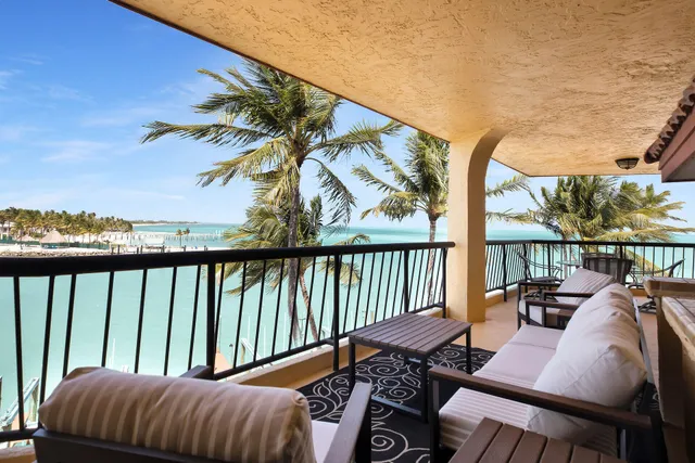 a view of a swimming pool with lawn chairs and a table