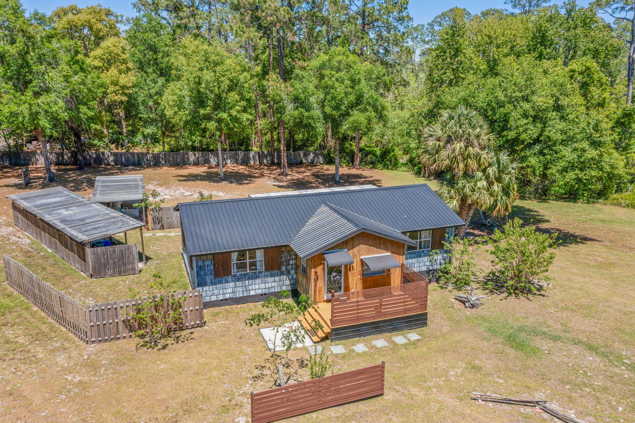958-954 Grand Rondo Crescent City, FL 32112 - Photo 2 of 23 a front view of a house with a yard garage and outdoor seating