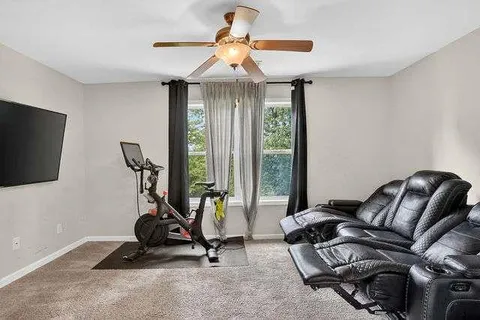 a room with gym equipment and windows