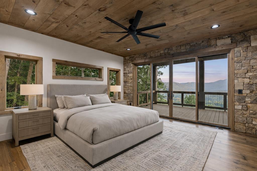 1 Riverview Circle Blue Ridge, GA 30513 - Photo 7 of 15 a bedroom with a large bed and a large window